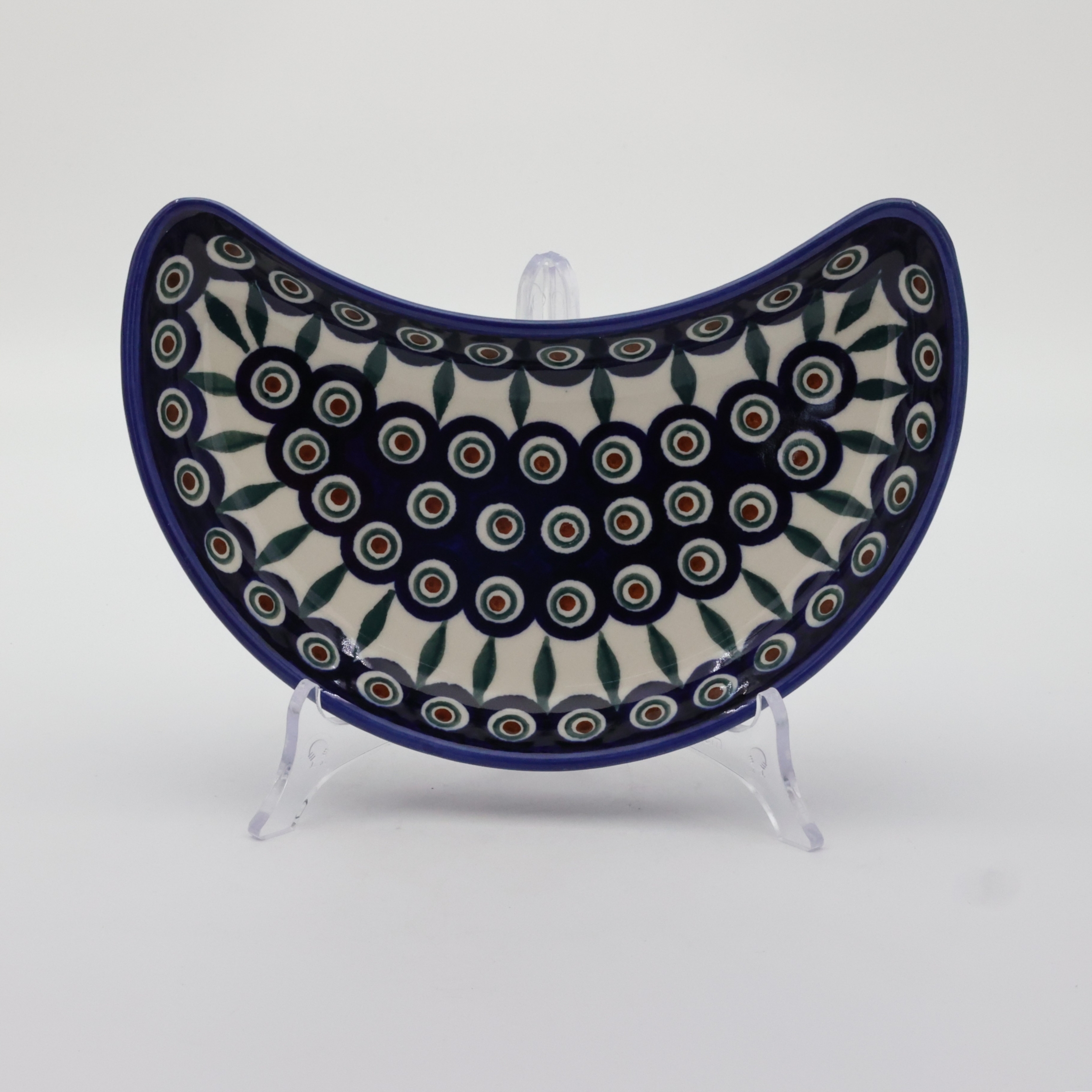 Unique Bolesławiec tray in crescent shape, perfect for serving snacks.